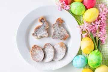 Easter still life composition breakfast. Easter eggs, egg pancakes and bunnies, pink hyacinth. Easter holiday.