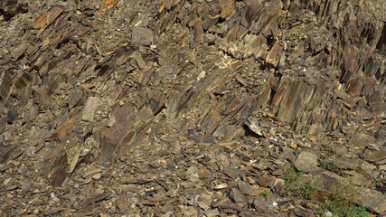 Stones at the foot of the mountain. Close-up of brown rock.