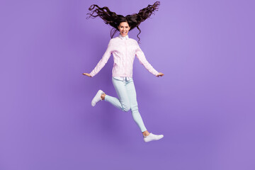 Fototapeta na wymiar Full length body size view of pretty funky cheerful wavy-haired girl jumping having fun running isolated on violet color background