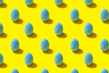  Easter seamless pattern. Blue painted egg on a yellow background. Creative packaging design in the concept of minimalism