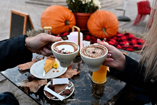 Couple sitting outdoors drinking coffee in autumn, Bosnia and Herzegovina