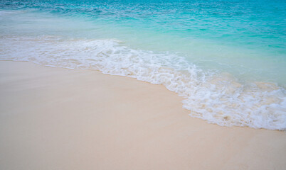 Fototapeta na wymiar Beach with white sand and soft blue ocean wave