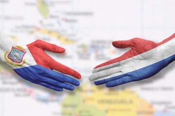 Sint Maarten and the Netherlands - Flag handshake symbolizing partnership and cooperation