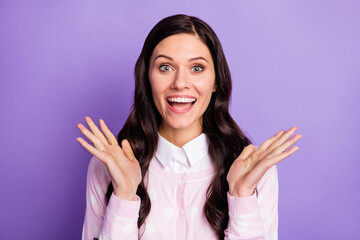 Portrait of attractive amazed cheerful wavy-haired girl good news reaction isolated over violet...
