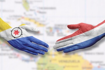Bonaire and the Netherlands - Flag handshake symbolizing partnership and cooperation
