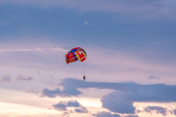Parasailing on sunset and blue sky background in tropical country