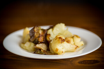 fried cauliflower with wild porcini mushrooms and onions in a plate