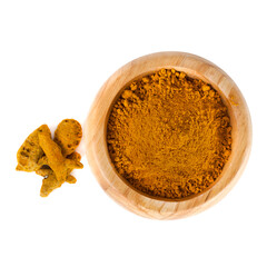 Turmeric powder spice heap in a wooden bowl with turmeric roots isolated on a white background. Top view.