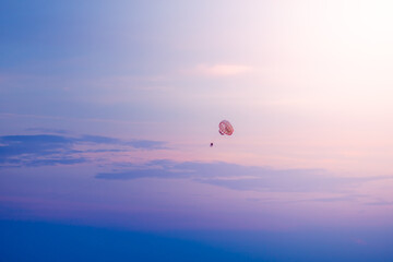 Parasailing in blue sky on sunny day
