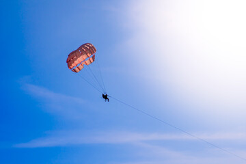 Parasailing in blue sky. Sports, active leisure, travel, vacation concept