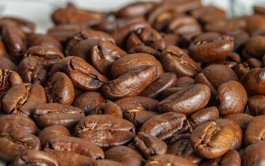 Roasted coffee beans on macro photography. Top view from the side
