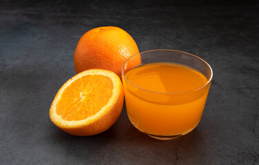 Fresh orange juice on dark stone table