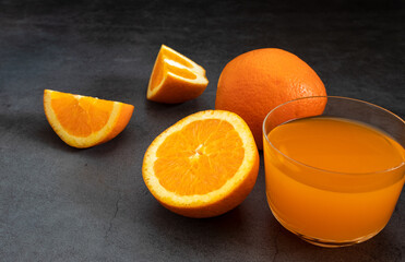 Fresh orange juice on dark stone table