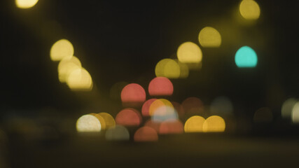 Fototapeta premium Abstract background of city lights bokeh. Blurred city lights . Defocused blurred lights. City at night . Traffic light. Traffic light bokeh. City bokeh night light .