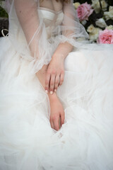the bride sits with her hands folded on the dress