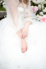 Obraz na płótnie Canvas the bride sits with her hands folded on the dress
