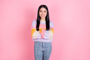 Photo of young happy smiling good looking confident asian woman with folded hands isolated on pink color background
