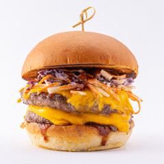Big burger with double cutlets, melted cheese and vegetable salad on white background.