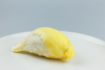 Single Durian on white plate, King of fruit of Thailand.