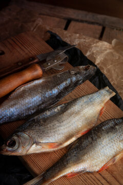 Dried vobla fish on wooden kitchen boad