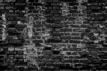 Texture of old dark scary dirty crumbling brick wall of ancient city. Uneven pitted surface of the brickwork of the damp basement with holes and worn. Decayed burnt brickwall background for 3D design