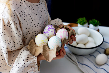 Little girl holding  paints easter eggs. Easter concept.	Preparing for Easter. Happy easter.