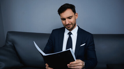 Businessman holding paper folder in hotel room