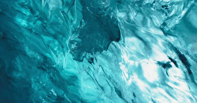 Deeply blue ice forming glacial ice cave slowly melting down in Iceland in winter 4K