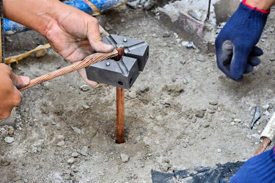 Workers working on protective earth system, used in construction of tall buildings.