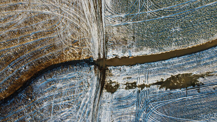 Drone shot of field covered in light snow