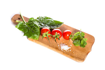 Cherry tomatoes on kitchen board, Healthy food isolated on a white. Vegetables for salad.