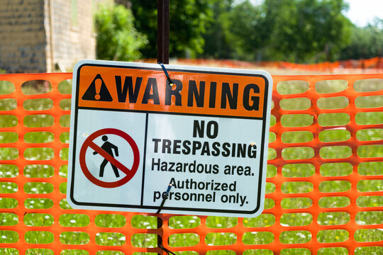 A warning sign indicating no trespassing indicating a hazardous area.