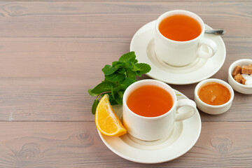 Cup of tea served with lemon and mint