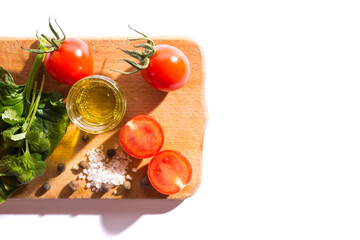 Flatley with cherry tomatoes. Olive oil in glass with cherry tomatoes. Herbs and vegetable with oil.