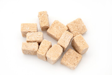 Brown cane sugar cubes isolated on white