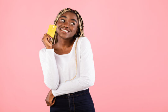 Black Woman Holding Credit Card And Dreaming