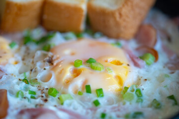 Close up of fried eggs with chopped spring onion.