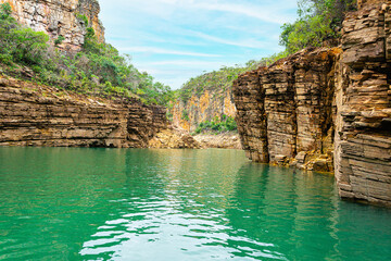 Lake with green water between walls of sedimentary rocks at Lake of Furnas, Capitólio MG Brazil.