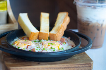 Pan fried egg with toppings and slice bread.