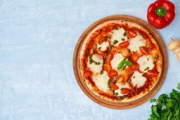 Top view of pizza Margherita on gray surface