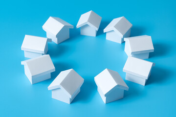 Fototapeta na wymiar 3D white houses model in circle on blue background for real estate property, housing development or community