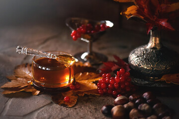 Honey with tea and berries at the table