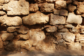 Fototapeta premium Texture of old stone wall surface. Ancient stone wall structure. Rock wall background.
