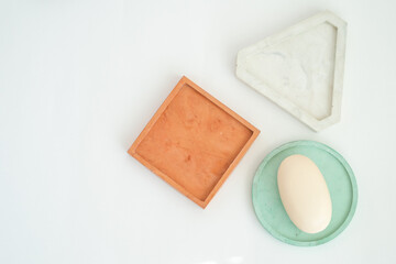 Soap on a mint color dish. Beauty, spa and wellness concept - close up of soap on gypsum tray. DIY soap on a geometric tray.