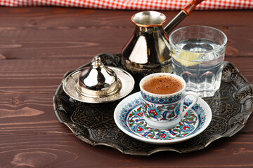 Cup of coffee in oriental style on metal tray