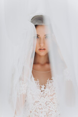 Wedding. Young Gentle Quiet Bride in Classic White Veil Looking Away
