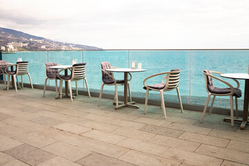 Empty outdoor cafe on the seafront promenade.