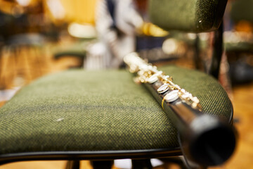 A close-up of a wooden instrument - oboe, lying on a chair.