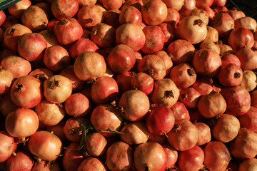 Pile of pomegranate fruits close up. Heap of pomegranate fruits as background.