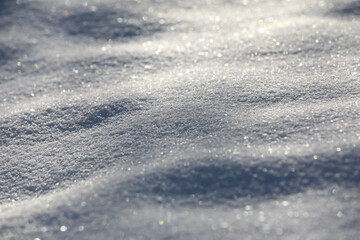 Snow close-up, winter landscape background with copy space, glittering snowflakes with bokeh effekt.